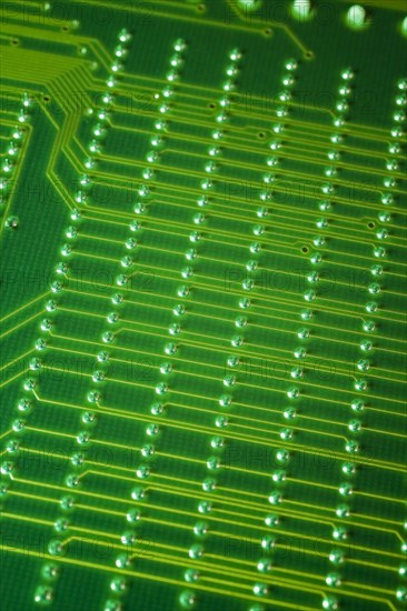 Close-up of fluorescent green lighted electronic computer circuit board with lines and silver solder points, Studio Composition, Quebec, Canada, North America
