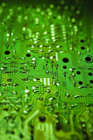 Close-up of green lighted electronic computer circuit board with silver solder points and lines, Studio Composition, Quebec, Canada, North America