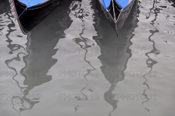 Reflections of two gondolas on the gently undulating water, Venice, Veneto, Italy, Europe