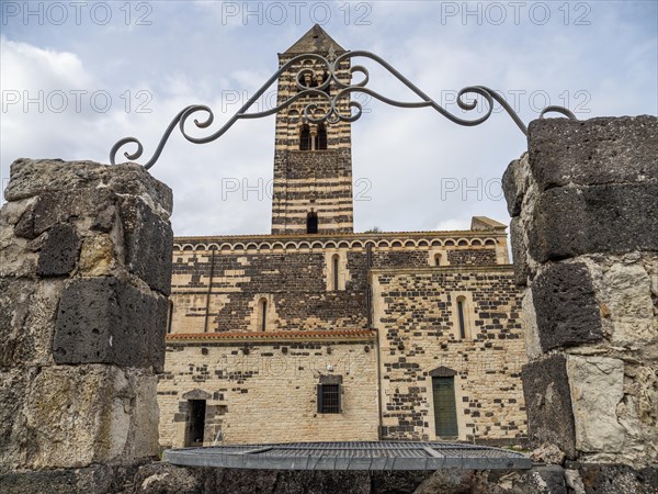 Fountain, behind the tower of the abbey church Santissima Trinita di Saccargia of the destroyed Camaldolese monastery, near Codrongianos, province of Sassari, Sardinia, Italy, Europe