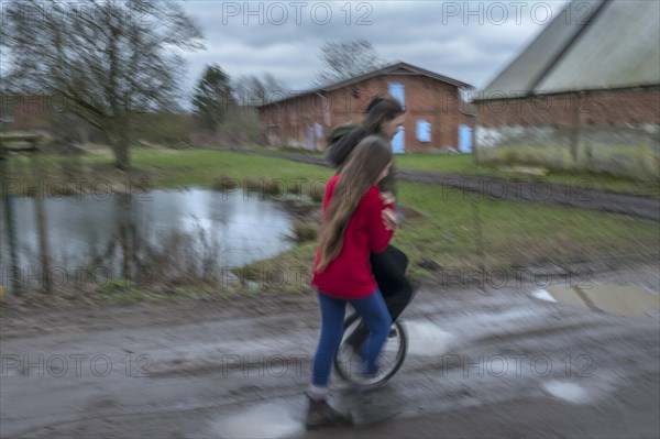 Girl with a unicycle, motion blur, Mecklenburg-Vorpommern, Germany, Europe