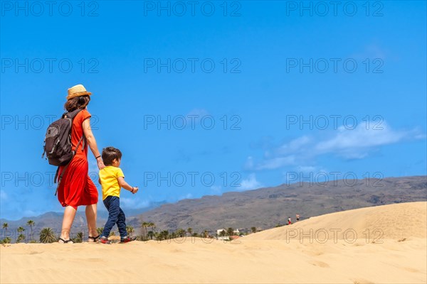 Mother and son enjoying in the dunes of Maspalomas on vacation, Gran Canaria, Canary Islands