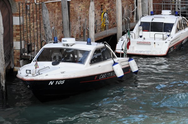 Boats of the Italian water police Carabinieri sailing through a canal in Venice, Venice, Veneto, Italy, Europe