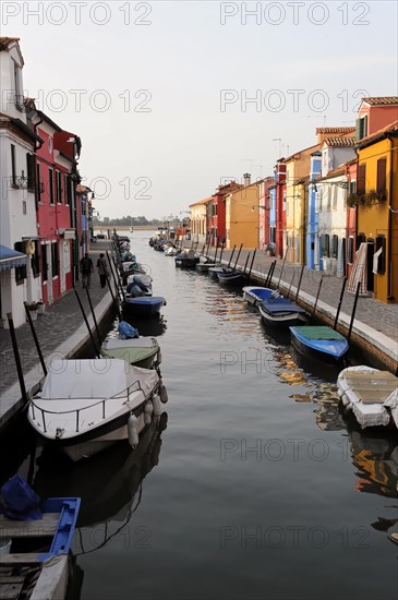 Colourful houses, Burano, Burano Island, A quiet canal flows between a row of colourful houses and parked boats, Burano, Venice, Veneto, Italy, Europe