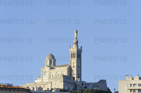 Church of Notre-Dame de la Garde, distant view of the Basilica of Notre-Dame de la Garde in Marseille on a hill under a blue sky, Marseille, Departement Bouches-du-Rhone, Region Provence-Alpes-Cote d'Azur, France, Europe