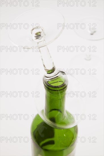 Close-up of upside down wine glass on top of consumed and empty red wine bottle, Studio Composition, Quebec, Canada, North America