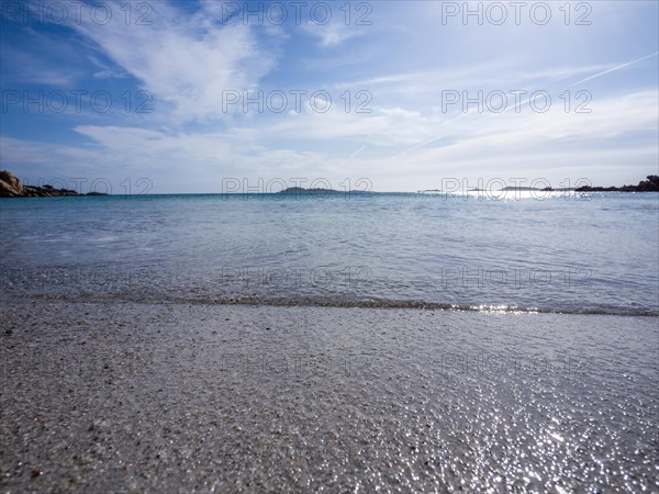 Waves reach the sandy beach, glittering sea, Capriccioli beach, Costa Smeralda, Sardinia, Italy, Europe