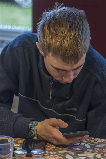 Young man on smartphone, Mecklenburg-Western Pomerania, Germany, Europe