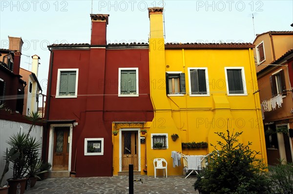 Colourful houses, Burano, Burano Island, Traditional red and yellow houses with shutters and plants, Burano, Venice, Veneto, Italy, Europe