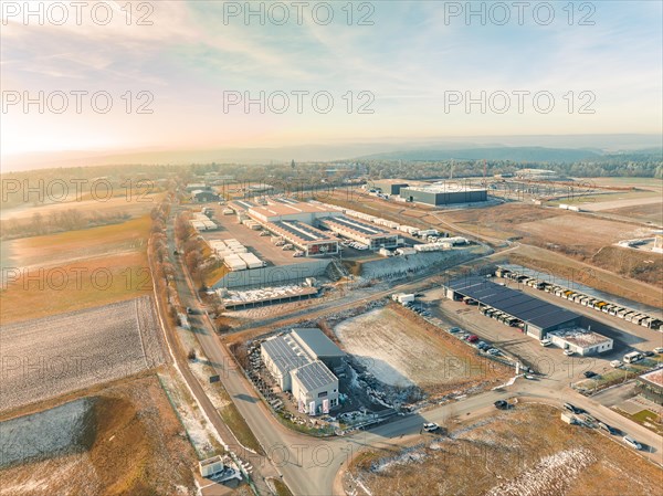 Spacious industrial area with warehouses and neighbouring fields in the morning light, sunrise, Nagold, Black Forest, Germany, Europe