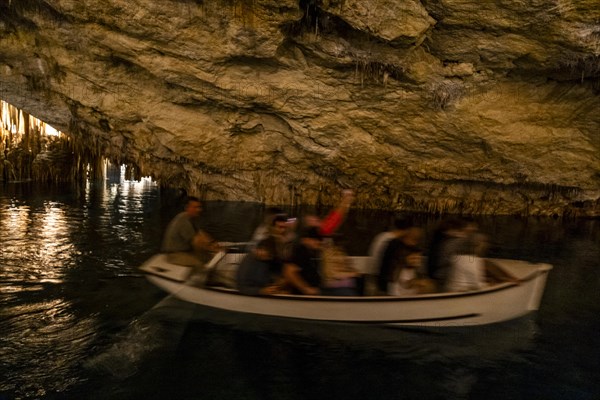 People in the boat on lake in amazing Drach Caves in Mallorca, Spain, Europe