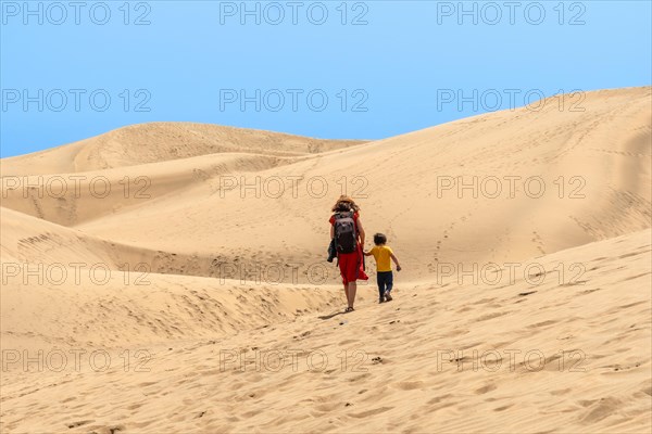 Mother and son enjoying in the dunes of Maspalomas on vacation, Gran Canaria, Canary Islands