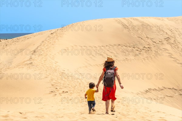 Mother and child on vacation in the dunes of Maspalomas, Gran Canaria, Canary Islands