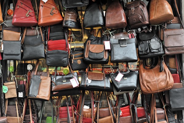 A variety of leather handbags lined up at a market stall, Venice, Veneto, Italy, Europe