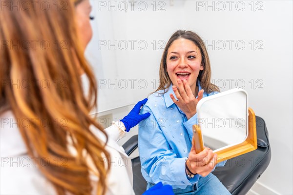 Aesthetic doctor and woman chatting animatedly after a facial rejuvenation treatment in the clinic