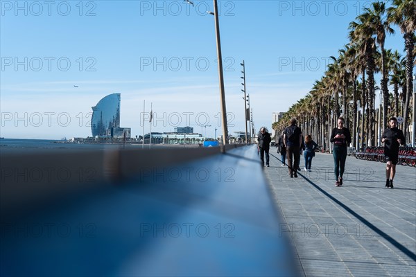 Promenade with joggers on the beach in Barcelona, Spain, Europe