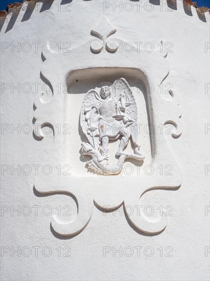 Stone sculpture, St George as dragon slayer, relief on the facade of the Stella Maris church, Porto Cervo, Costa Smeralda, Sardinia, Italy, Europe