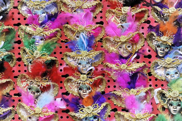 Colourful carnival masks with feather decorations present the lively celebration of the Venetian carnival, Venice, Veneto, Italy, Europe