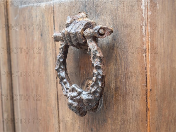 Hand holding door knocker, Alghero, Sardinia, Italy, Europe