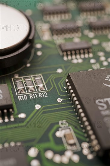 Close-ip of green computer circuit board with hard disc, memory chip, silver solder points and lines, Studio Composition, Quebec, Canada, North America