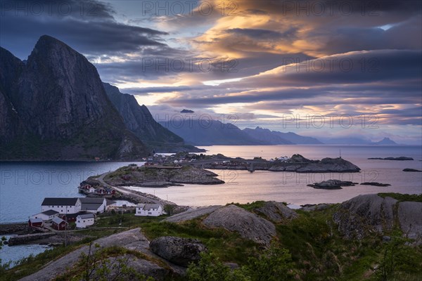 Landscape on the Lofoten Islands, view of Toppoya, Hamnoy and the sea, along Moskenesoya, Flakstadoya and Vestvagoya. Several coloured lenticular clouds (lenticularis) in the sky. At night at the time of the midnight sun. Early summer. Moskenesoya, Lofoten, Norway, Europe