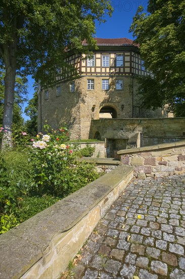 Access to the moated castle Sachsenheim, Grosssachsenheim Castle, former moated castle, archway, cobblestones, path, wall, bridge, crossing, coat of arms, with inscription, exterior lights, lamps, architecture, historic building from the 15th century, Sachsenheim, Ludwigsburg district, Baden-Wuerttemberg, Germany, Europe