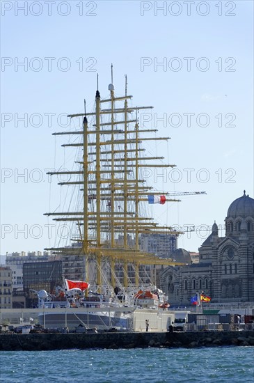 Marseille in the morning, Historic tall ship in the harbour in front of the city skyline under a blue sky, Marseille, Departement Bouches-du-Rhone, Region Provence-Alpes-Cote d'Azur, France, Europe