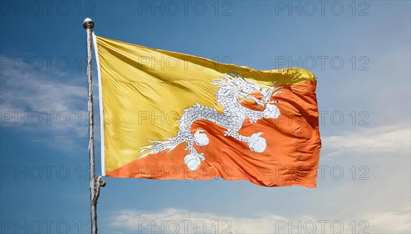 Flag, the national flag of Bhutan flutters in the wind