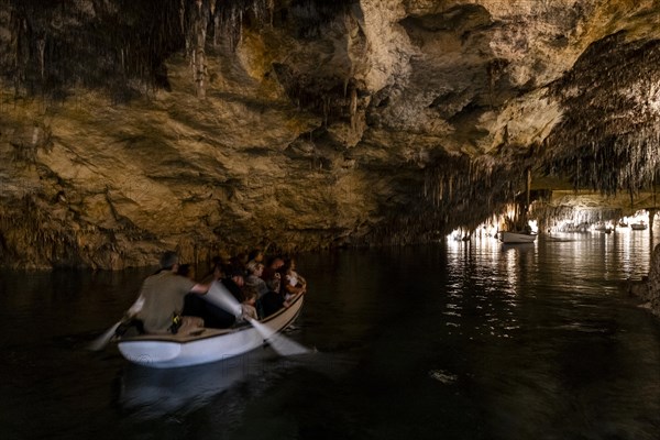 People in the boat on lake in amazing Drach Caves in Mallorca, Spain, Europe