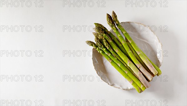 Green asparagus on a white plate with a clean background, AI generated, AI generated