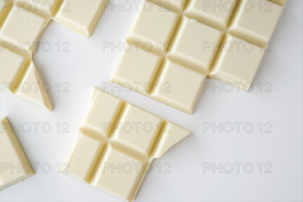 Broken up white chocolate bars, AI generated