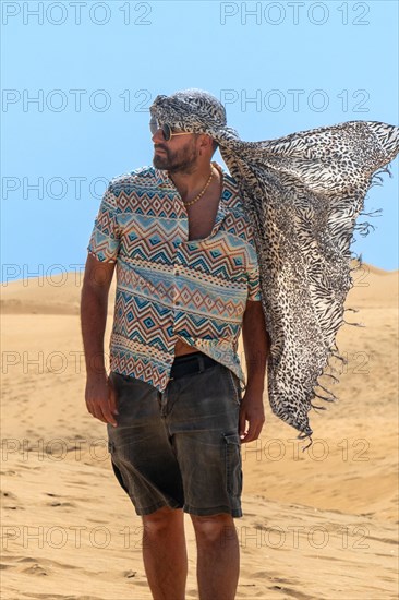 Portrait of tourist man with turban in summer in the dunes of Maspalomas, Gran Canaria, Canary Islands