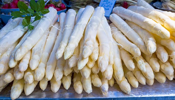 Stacks of fresh asparagus, presented on a market stall under daylight, AI generated, AI generated