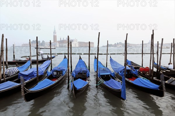 Several gondolas moored with a view of historic Venetian architecture, Venice, Veneto, Italy, Europe