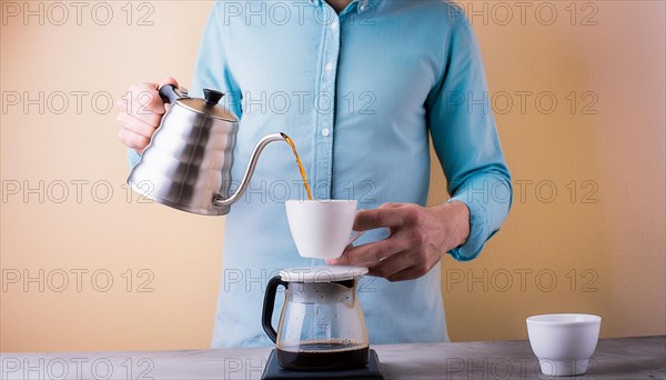 Man in a blue shirt focused on pouring hot water from a gooseneck kettle into a coffee filter, horizontal, AI generated