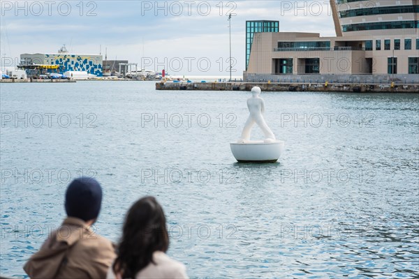 Two people sitting at the old harbour in Barcelona, Spain, Europe