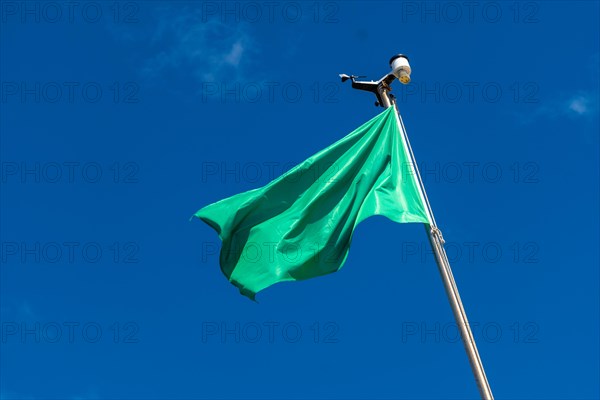 Green flag on the beach in summer summer, lifeguards sign that you can swim