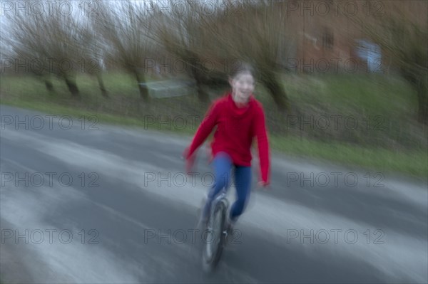 Girl, 10 years old, riding a unicycle, motion blur, Mecklenburg-Vorpommern, Germany, Europe