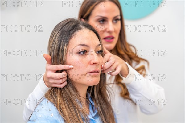 Aesthetic doctor showing the facial improvements that a patient could undergo in the clinic