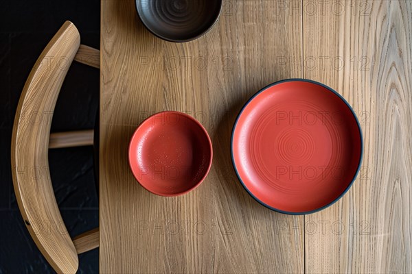 Minimalist table setting featuring red bowls with circular patterns on a wooden surface, AI generated