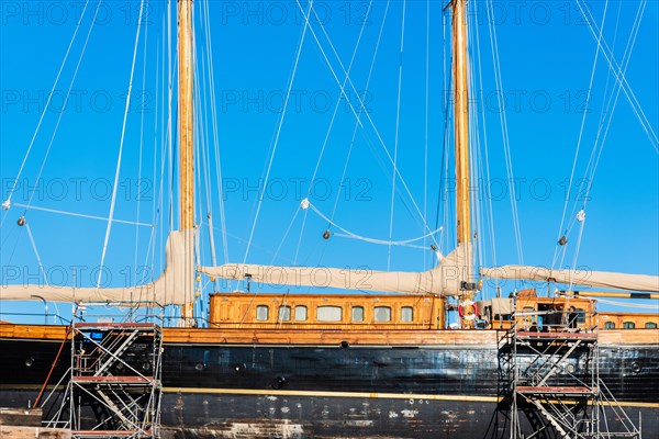 Old sailing ship in a shipyard in the old harbour of Barcelona, Spain, Europe