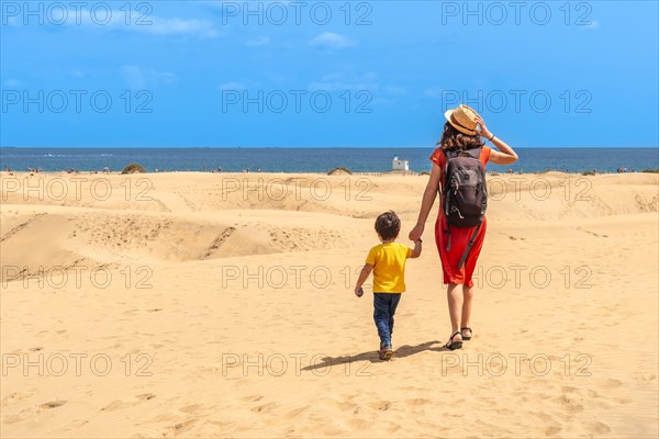 Mother and child on summer vacation in the dunes of Maspalomas, Gran Canaria, Canary Islands