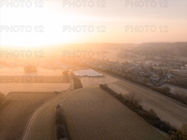 Winter morning atmosphere over a village surrounded by fields and fog, Gechingen, Black Forest, Germany, Europe