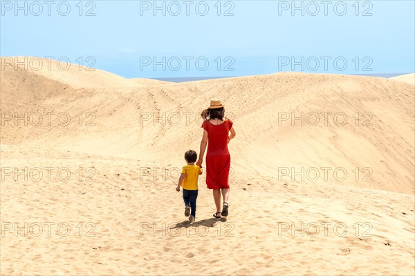 Mother and son tourists exploring the dunes of Maspalomas, Gran Canaria, Canary Islands