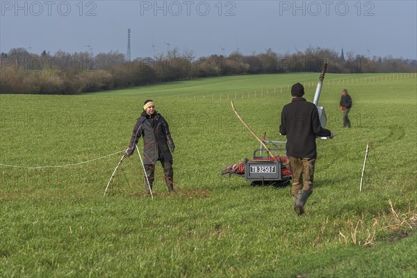 Shepherd and his daughter fence a new pasture with a solar panel for the electric fence, Mecklenburg-Western Pomerania, Germany, Europe