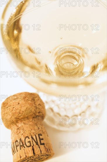 Top view and close-up of filled champagne glass and bottle cork on white background, Studio Composition, Quebec, Canada, North America