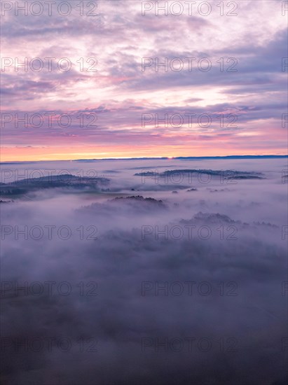 Gentle hills rise out of the fog under pink-coloured clouds, Gechingen, Black Forest, Germany, Europe