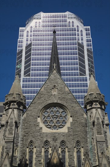 Old Christ Church Cathedral facade with rose window and modern architectural steel and blue tinted glass windows KPMG office tower in summer, Montreal, Quebec, Canada, North America