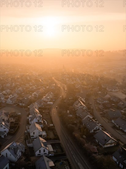 Sunrise casts a soft light on a town and its church towers in the distance, Gechingen, Black Forest, Germany, Europe