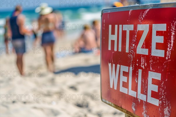 Warning sign with German text 'Hitzewelle' (Heat wave) in front of blurry sunny beach with people. KI generiert, generiert, AI generated